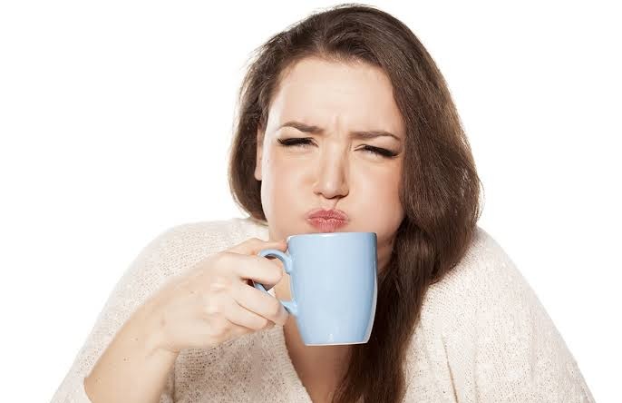 A cup of coffee being tasted to work out why the coffee tastes bitter