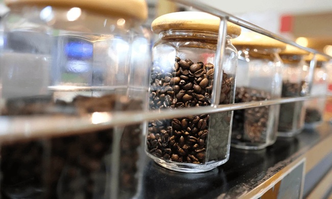 Coffee beans stored in an airtight opaque container to keep them fresh
